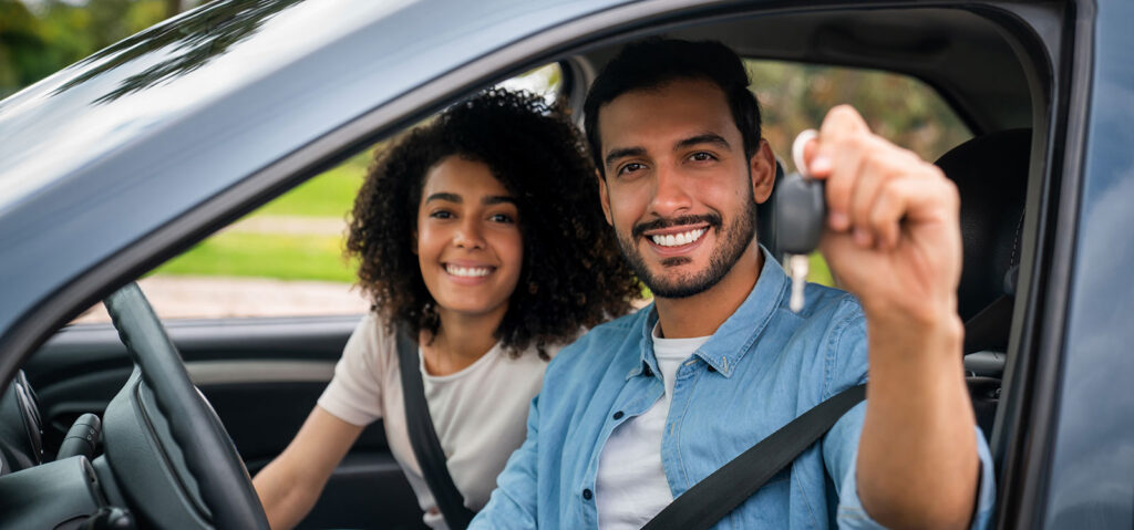 happy couple holding keys